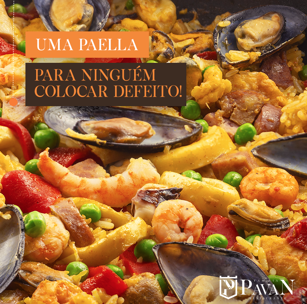 Close-up of paella with seafood and vegetables in a pan, the words