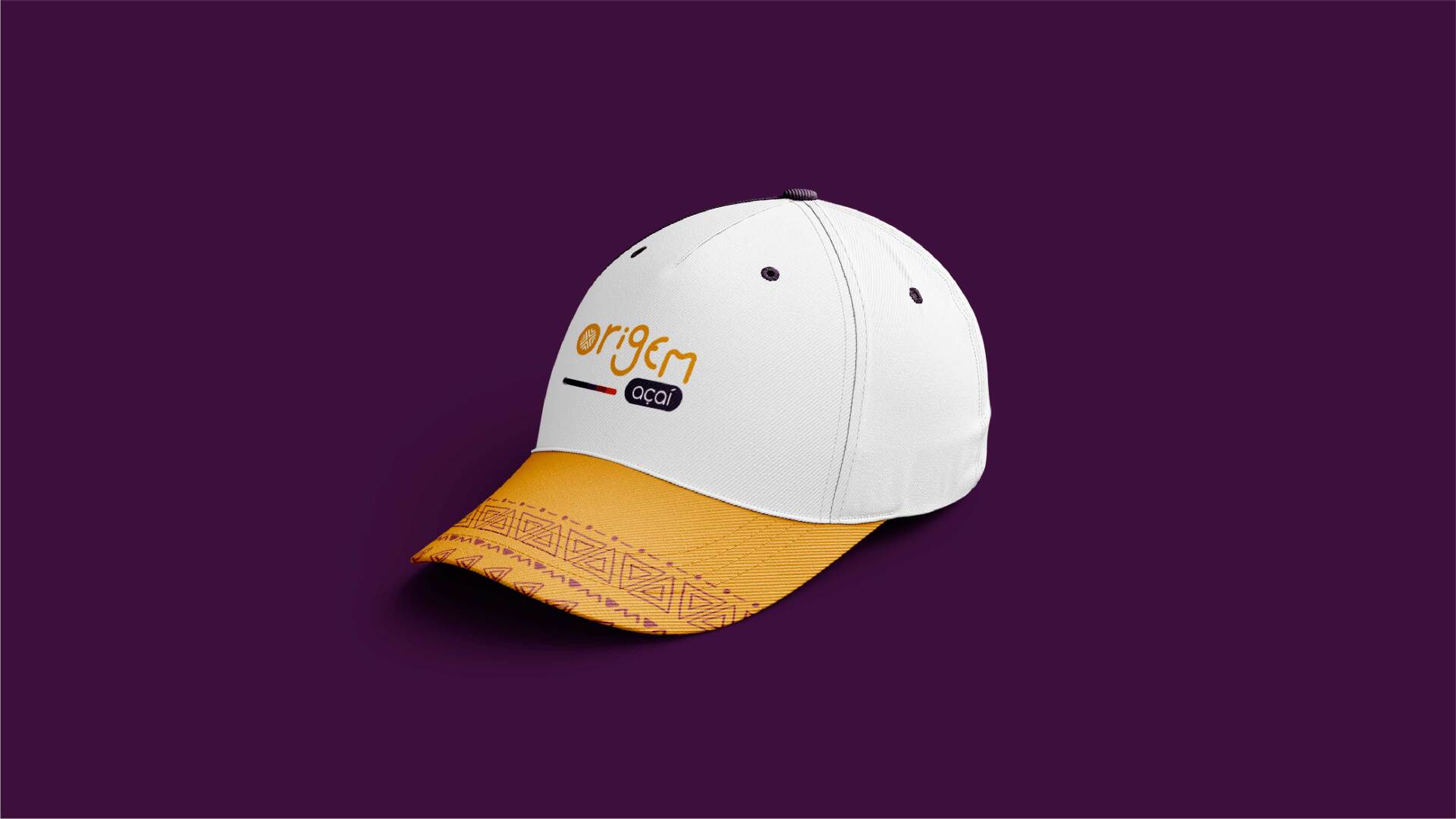 A white and yellow baseball cap is sitting on a purple surface.