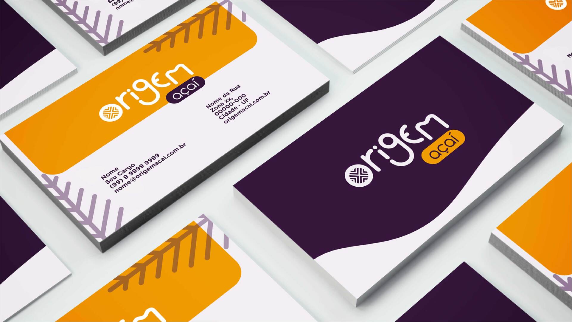 A bunch of business cards are stacked on top of each other on a table.