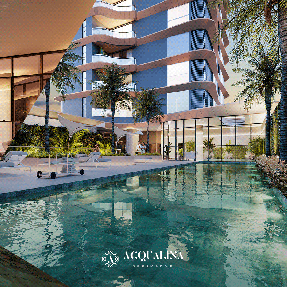 Um edifício alto e moderno com piscina e palmeiras. O edifício azul tem varandas curvas com vista para a água.