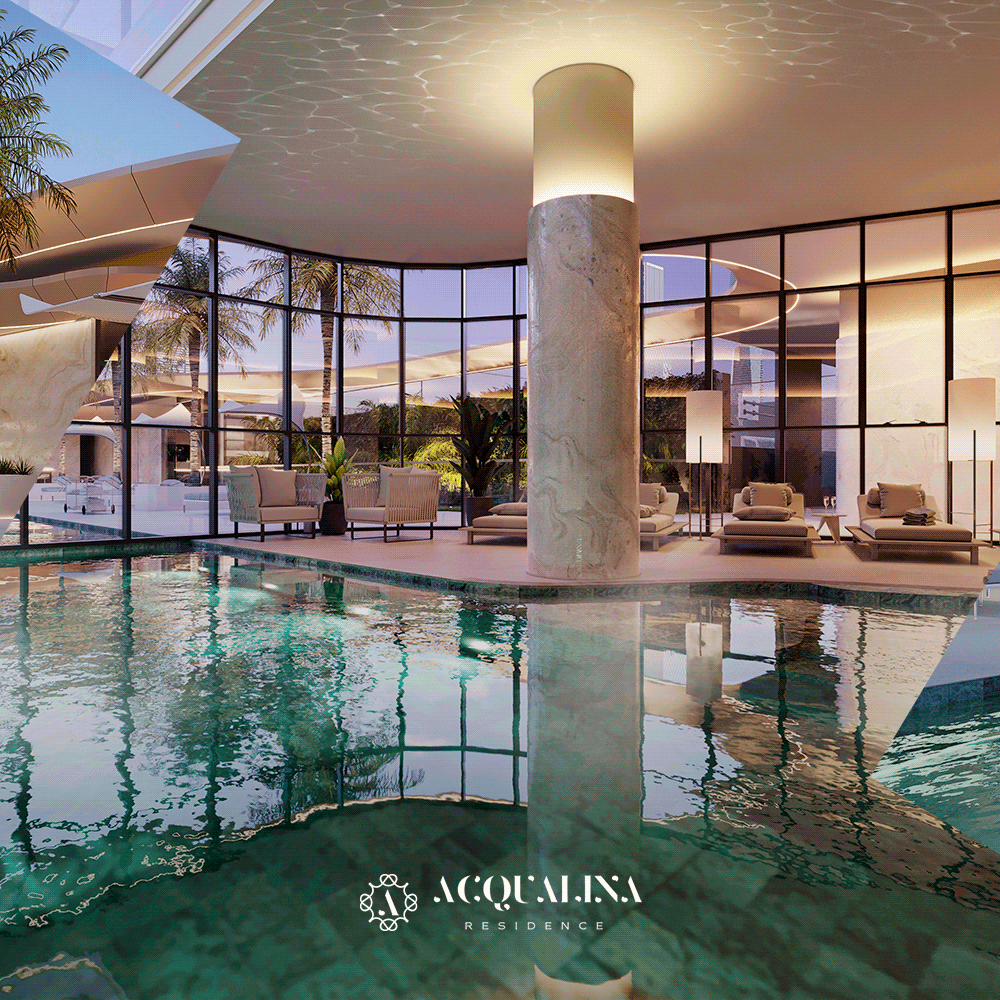 Uma área de piscina coberta em uma residência de luxo. As comodidades incluem uma coluna central iluminada, janelas amplas e assentos confortáveis.