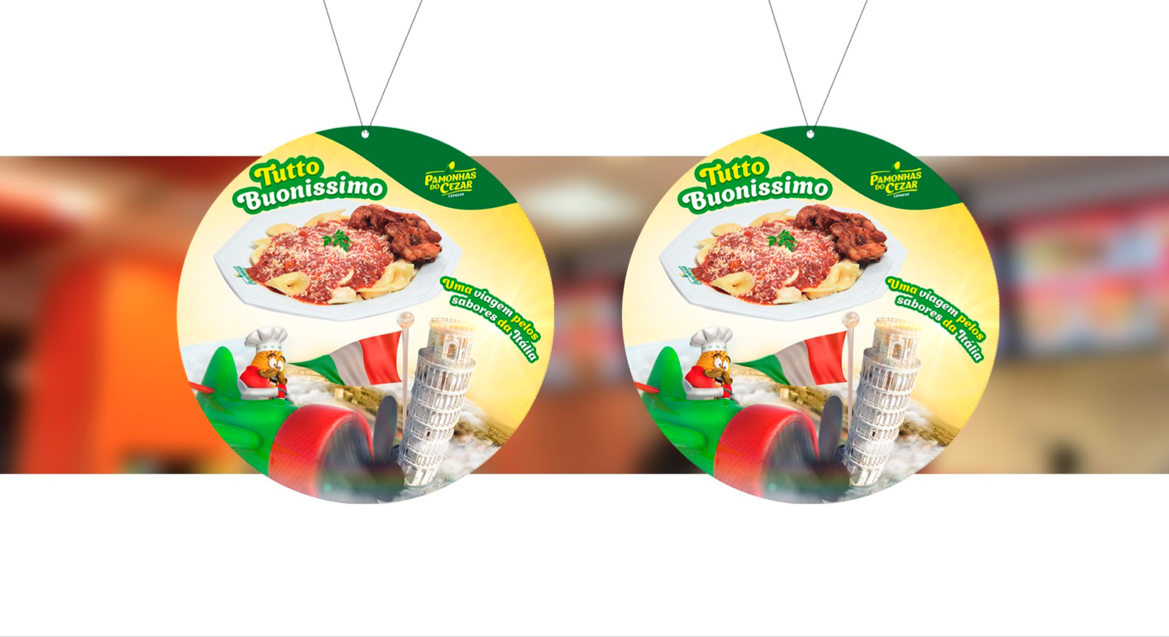 Dois purificadores de ar redondos com uma imagem de comida e logotipo, pendurados em um fundo desfocado de restaurante.