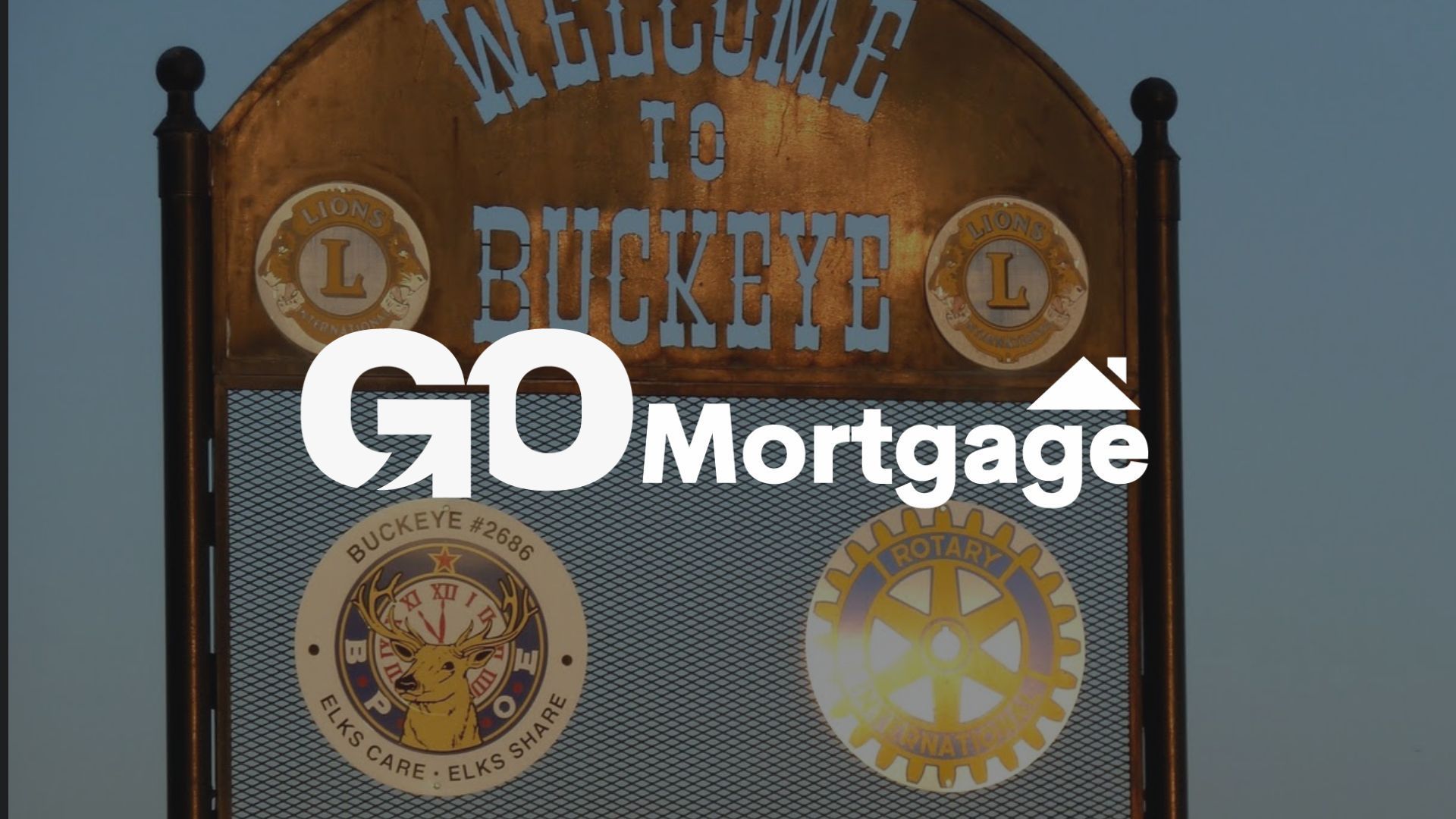 Sign: Welcome to Buckeye, with GO Mortgage logo overlay. Lions, Rotary Club, and Buckeye Guide emblems.