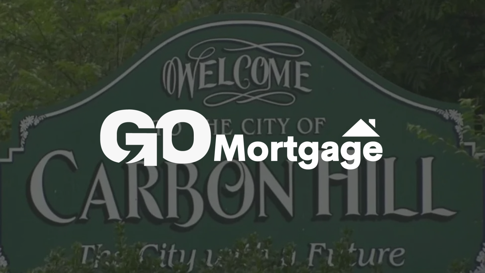 A green welcome sign to Carbon Hill with 