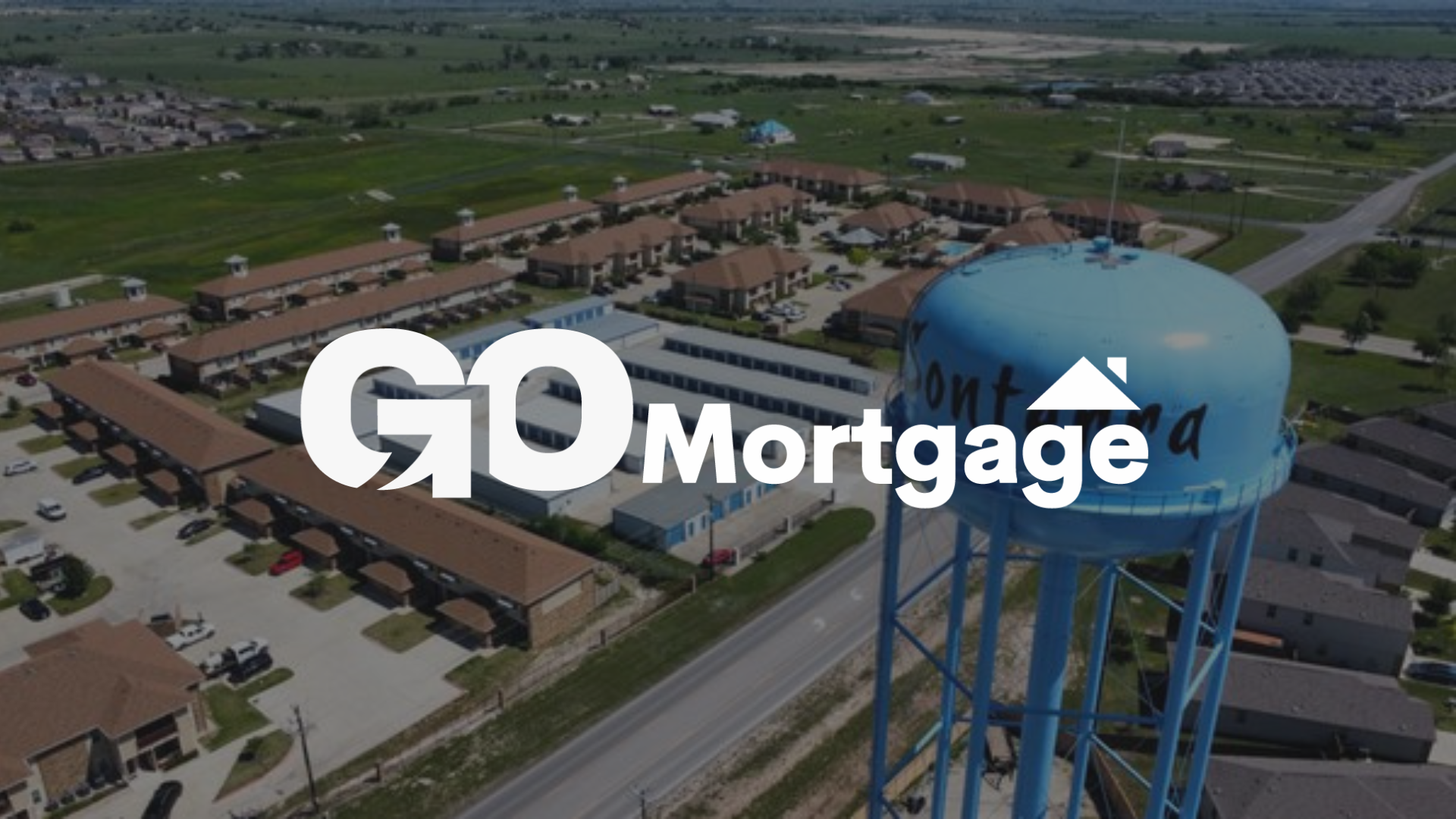 Aerial view: GO Mortgage logo overlaid on a blue water tower; townhouses and a road are visible in the background.