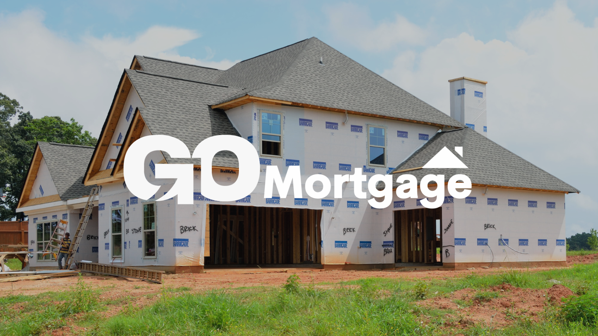 A house is being built in a field with the go mortgage logo in the foreground.