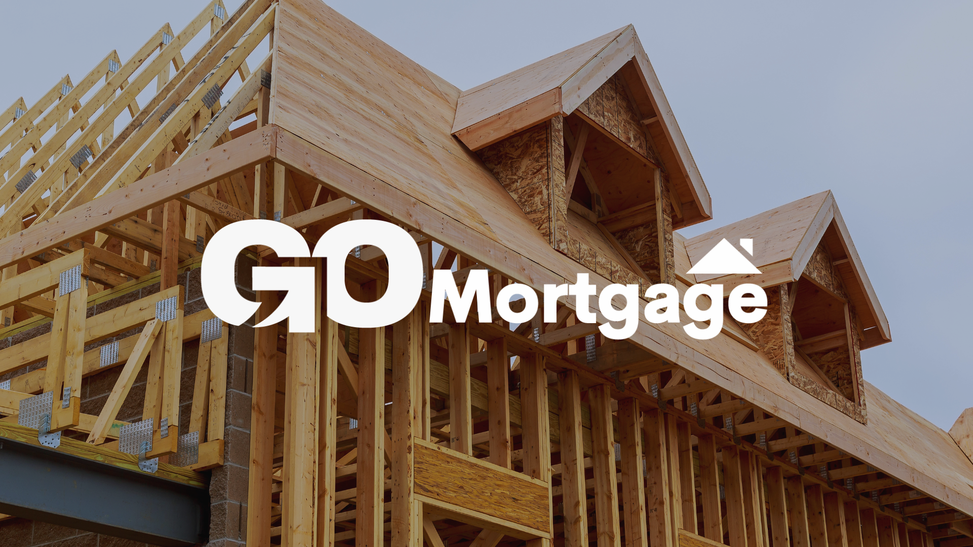 A house is being built with the go mortgage logo on it.
