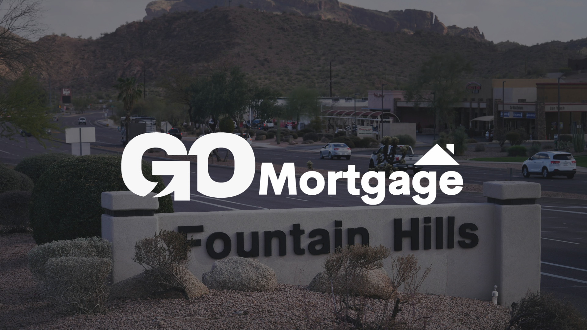 GO Mortgage logo over Fountain Hills sign; Arizona mountain backdrop.
