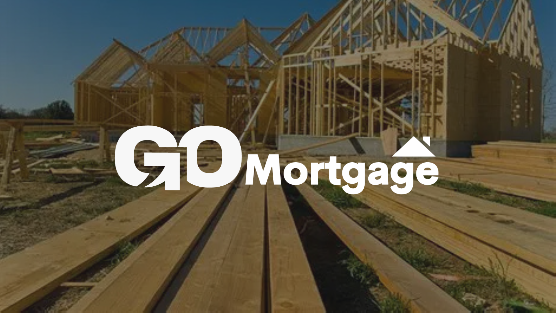 A house is being built with a lot of wood in front of it go mortgage logo