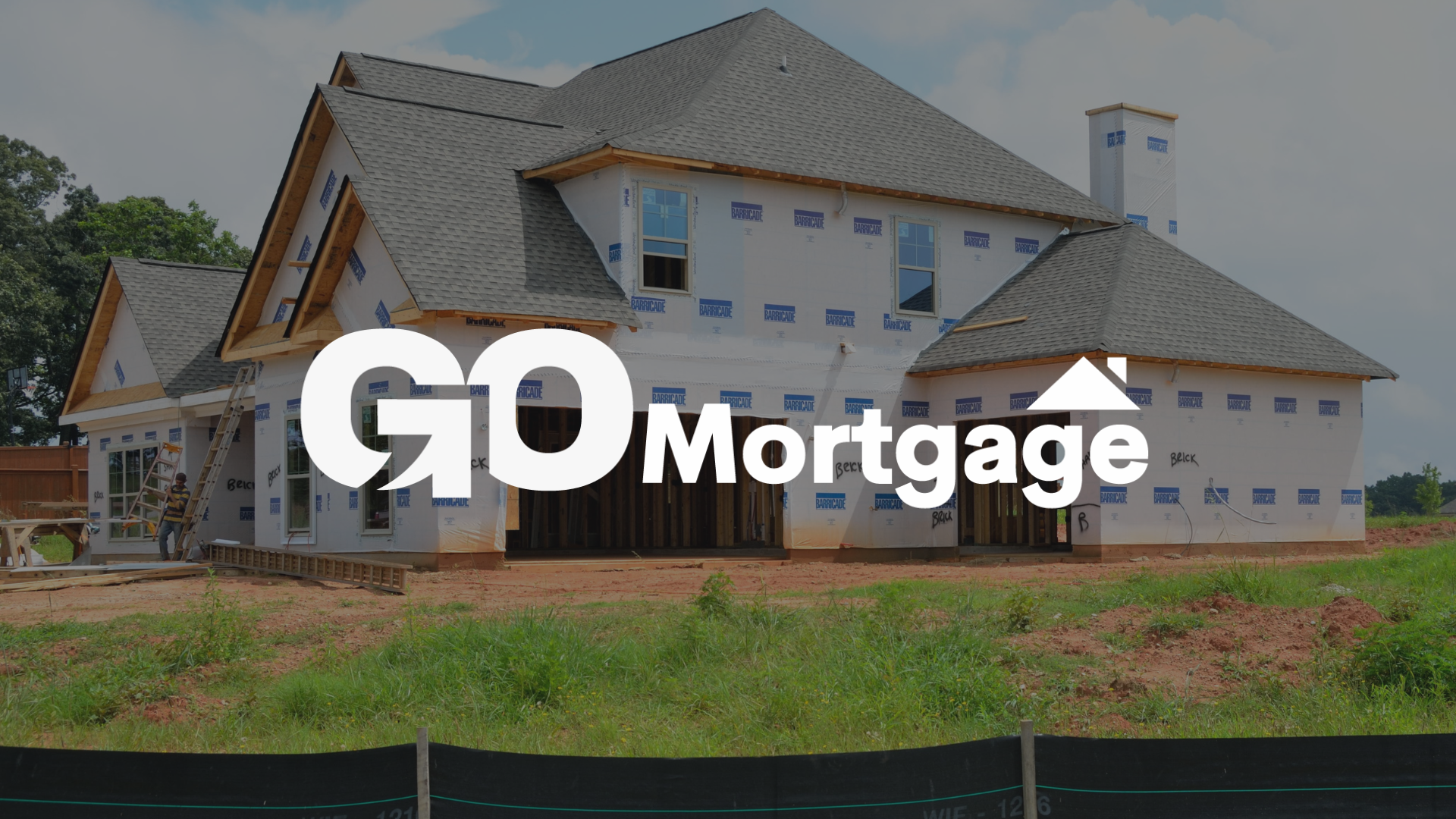 A house is being built in a field with the go mortgage logo in the foreground.