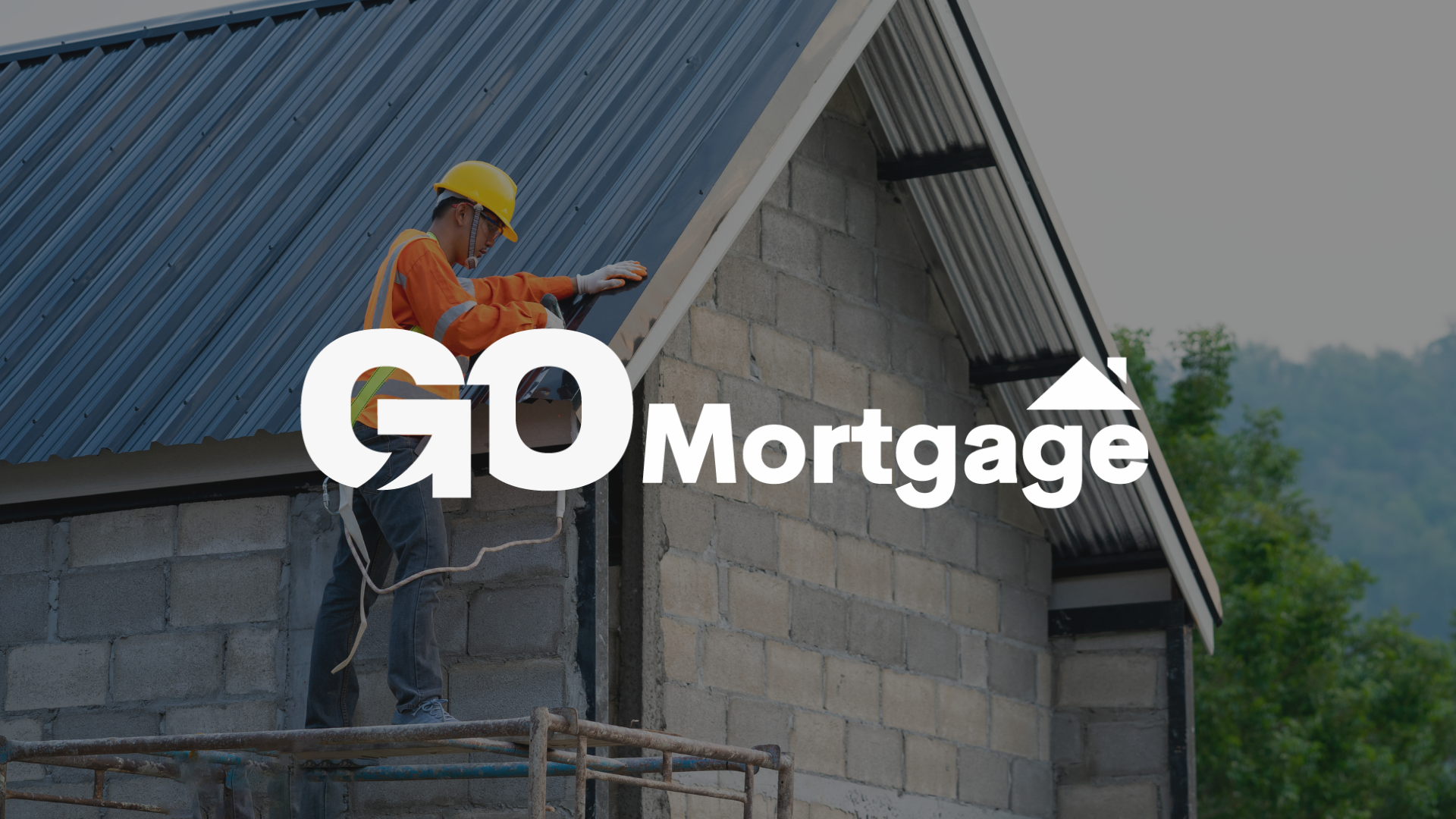 A man is working on the roof of a house under construction.
