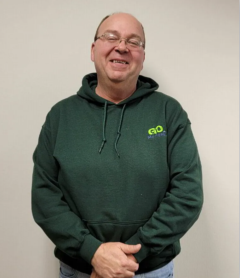 a man wearing a green hoodie with go on it