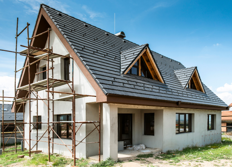 A house is being built with scaffolding around it.