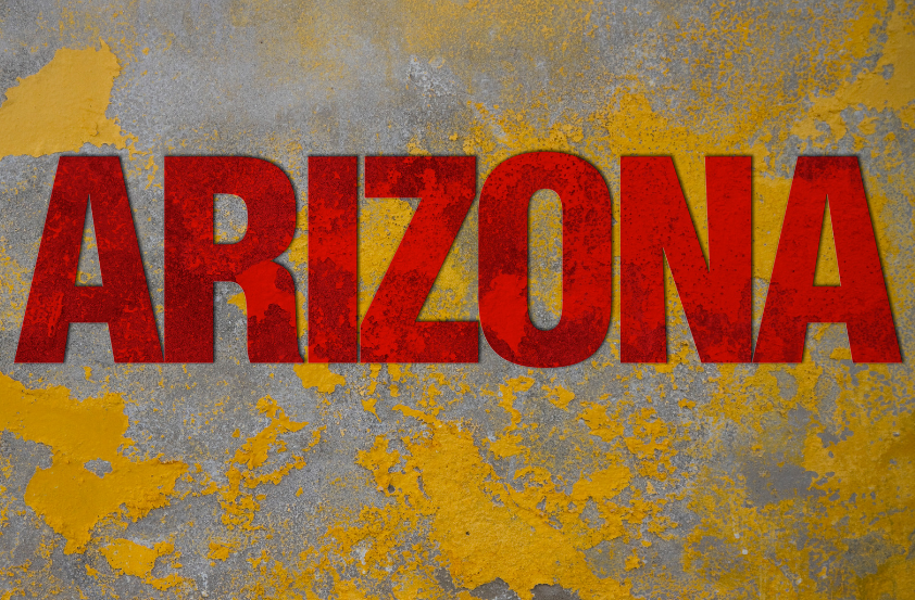 The word arizona is painted on a yellow and gray wall.