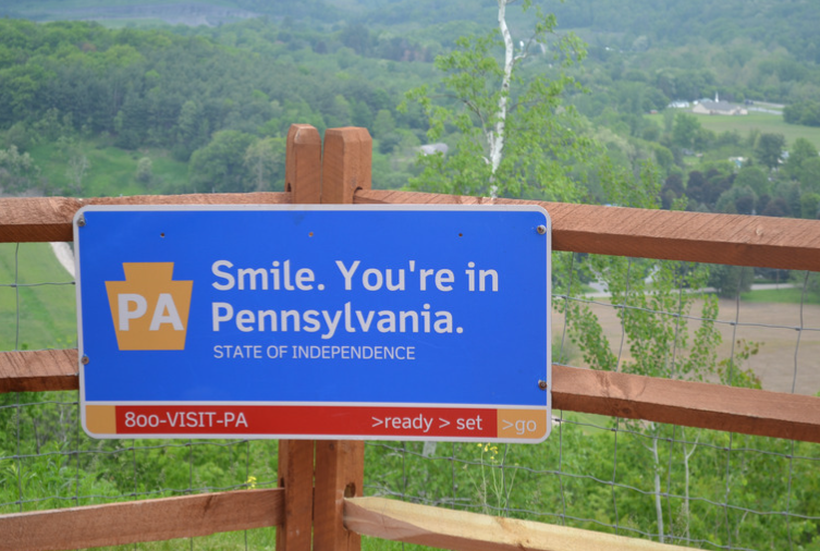 A blue sign that says smile you 're in pennsylvania