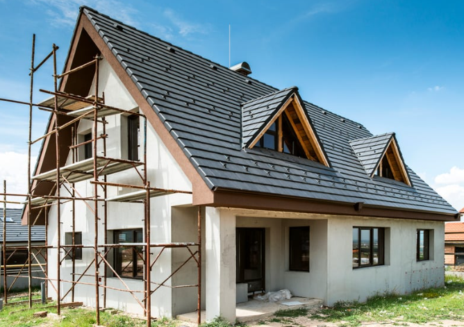 A house is being built with scaffolding around it.