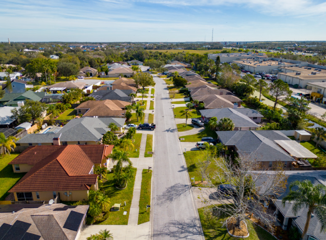 An aerial view of a residential neighborhood with lots of houses and trees.