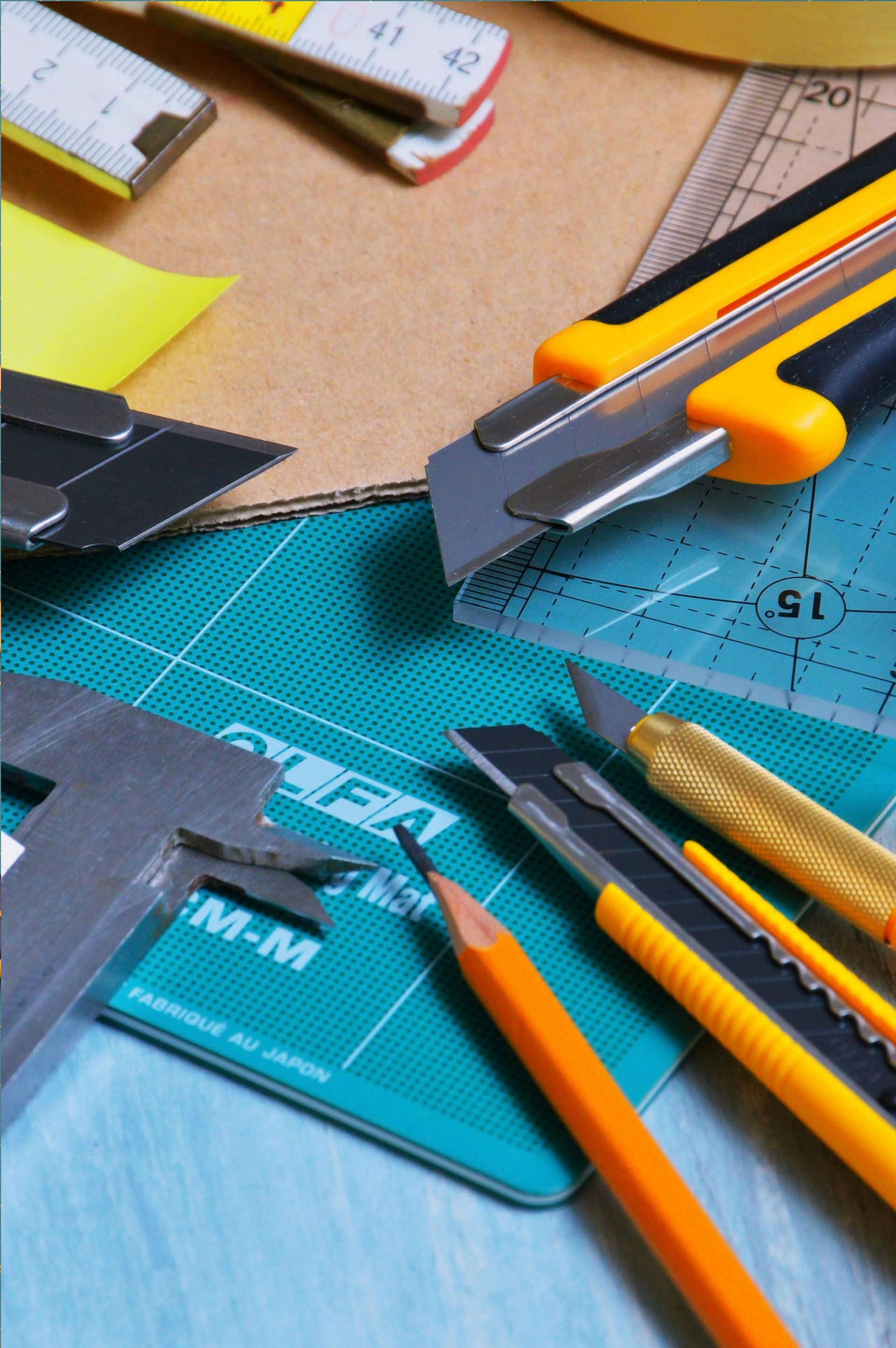 A bunch of tools are laying on a cutting mat