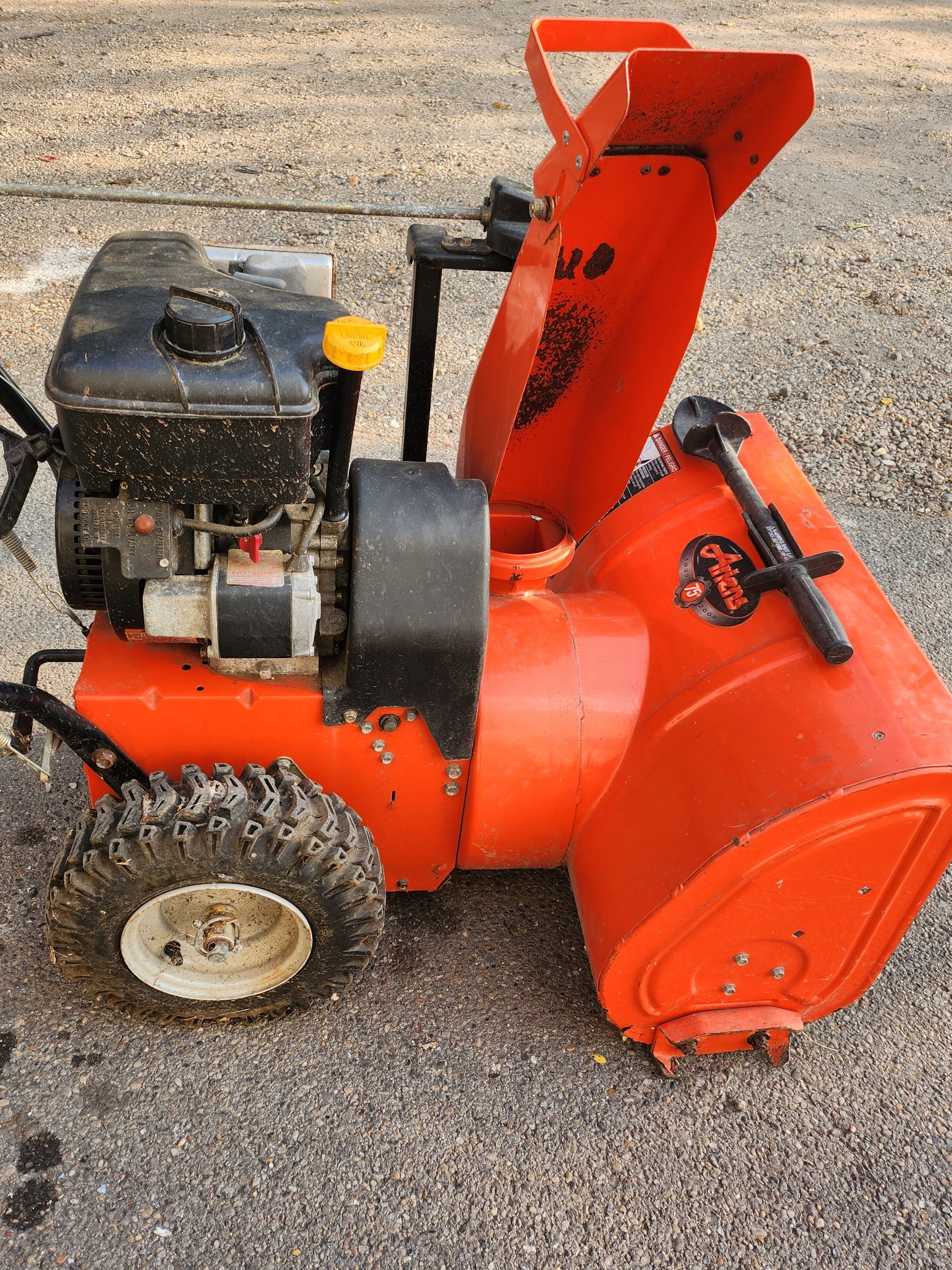 A row of lawn mowers sitting on top of a lush green lawn.