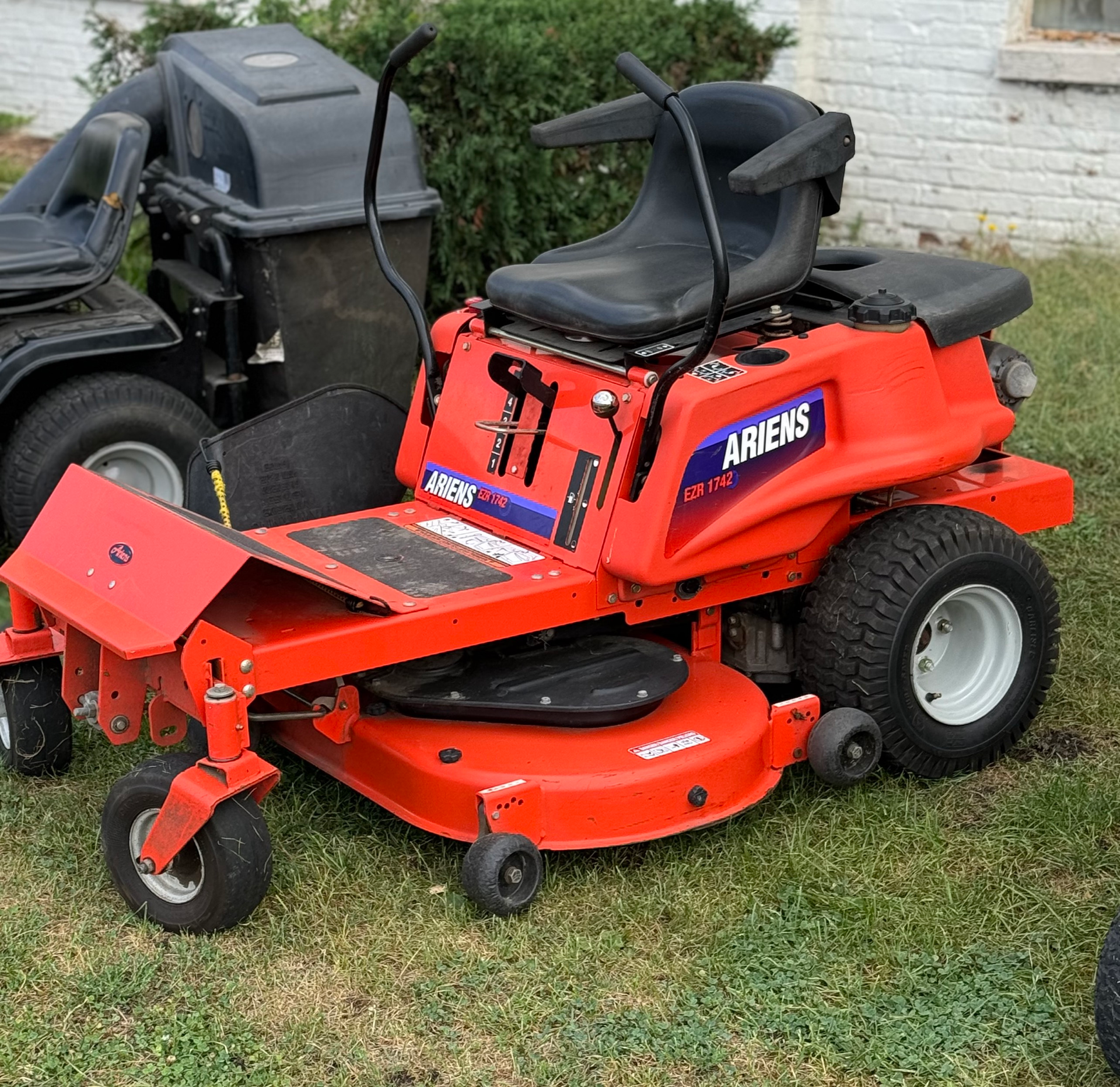 A red lawn mower with the word ariens on it