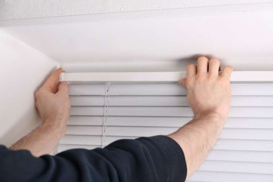installation of window blinds in progress