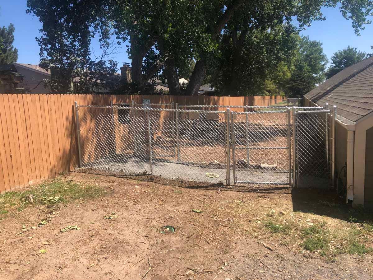 A backyard with a chain link fence and a shed.