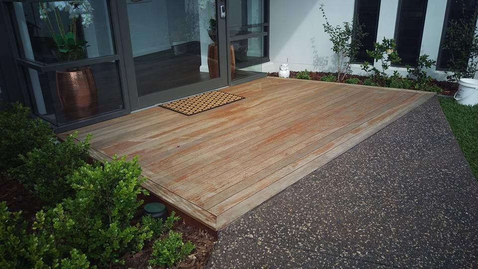Wooden Deck With A Door Mat In Front Of A House — Shane's Painting & Timber Restorations In Highfields, QLD
