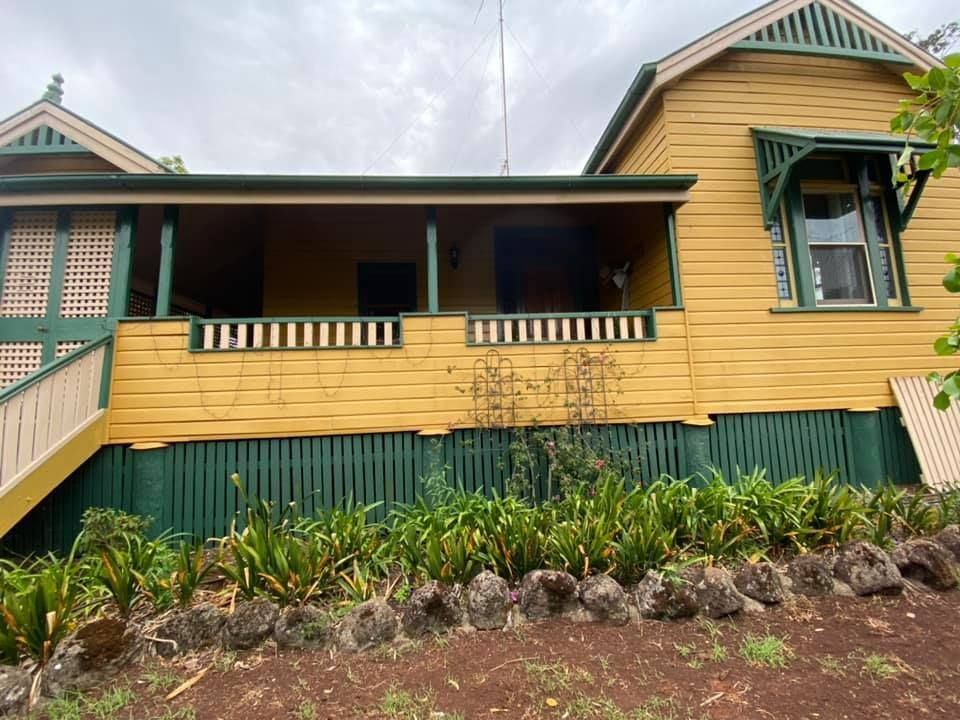 Yellow House With A Green Fence And Stairs — Shane's Painting & Timber Restorations In East Toowoomba, QLD