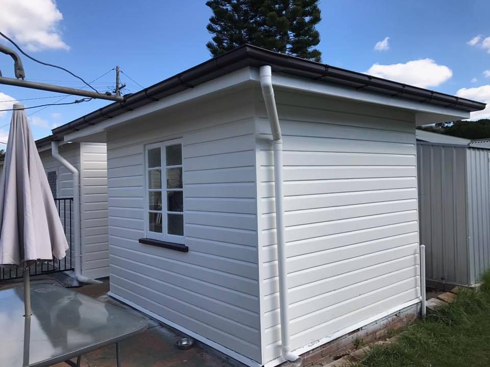 White House With A Table And Umbrella In Front Of It — Shane's Painting & Timber Restorations In East Toowoomba, QLD