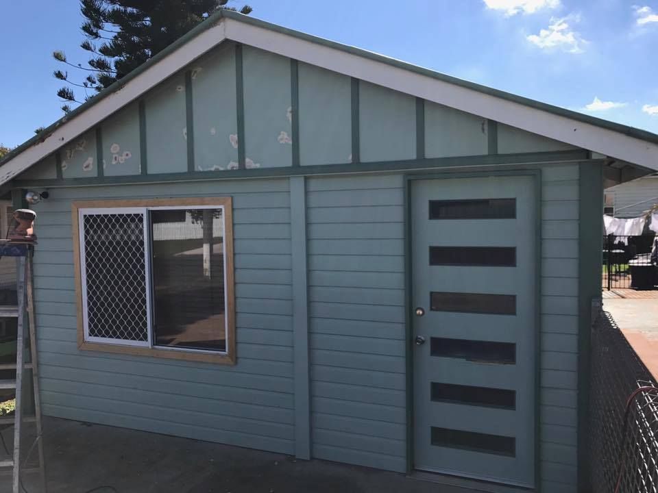 Small Blue House With A Ladder In Front Of It — Shane's Painting & Timber Restorations In Helidon, QLD