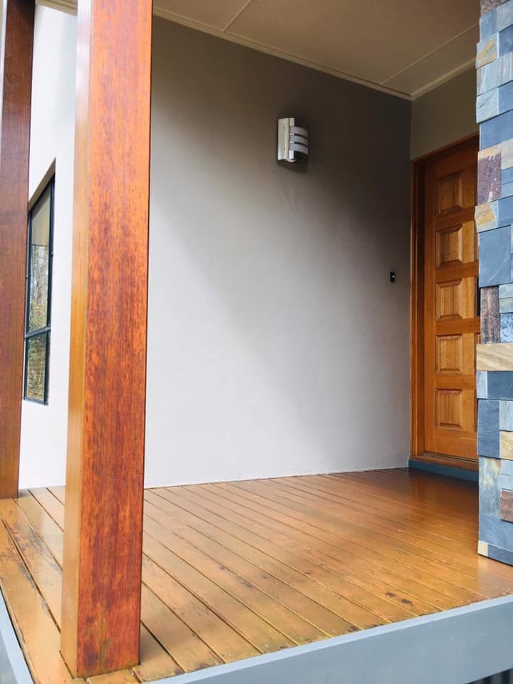 Restored Wooden Floor And Pillars In Front Of A House — Shane's Painting & Timber Restorations In East Toowoomba, QLD