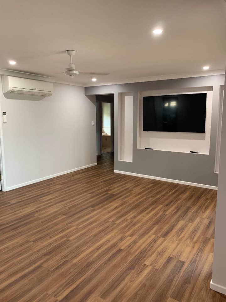 Living Room With Wooden Floors And A Flat Screen Tv — Shane's Painting & Timber Restorations In East Toowoomba, QLD