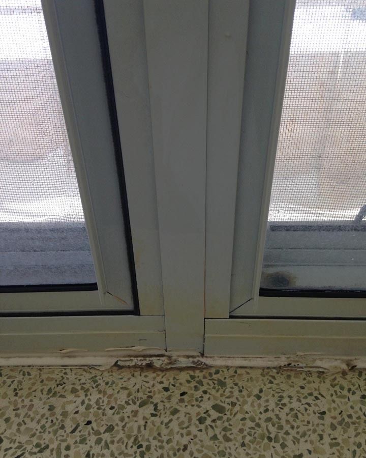 A close up of a window with a screen on it.