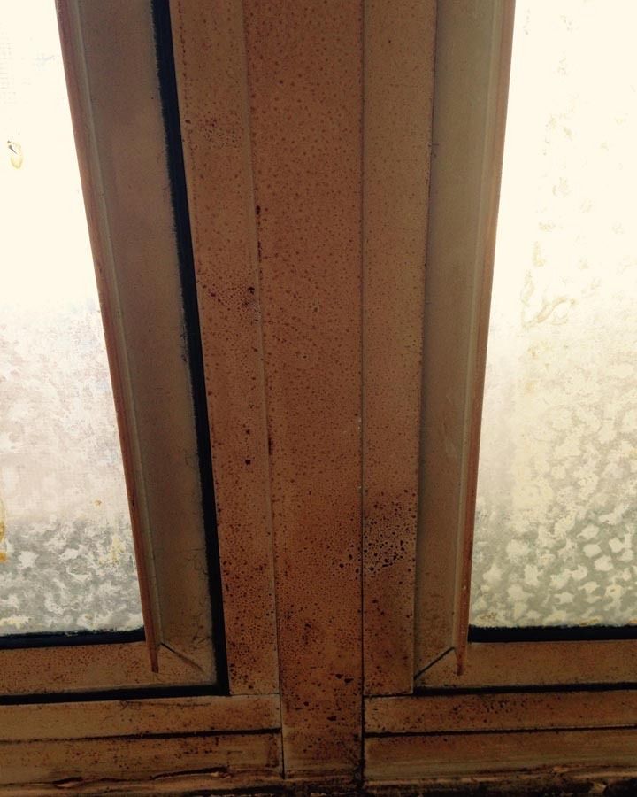 A close up of a window with stains on it.