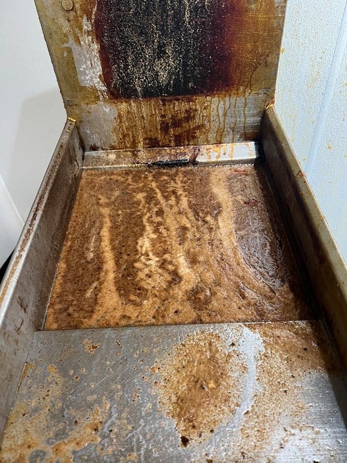 A dirty stove top with a lot of stains on it.