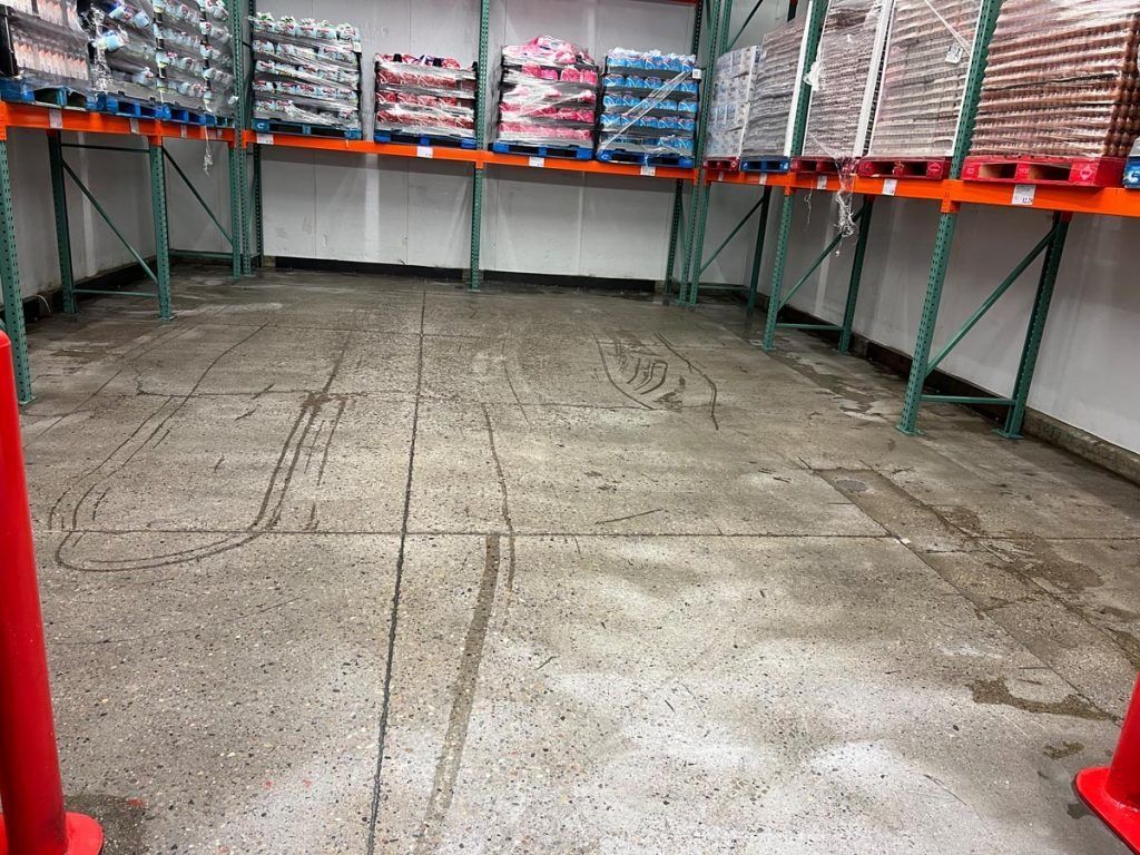 A warehouse filled with lots of shelves and pallets.