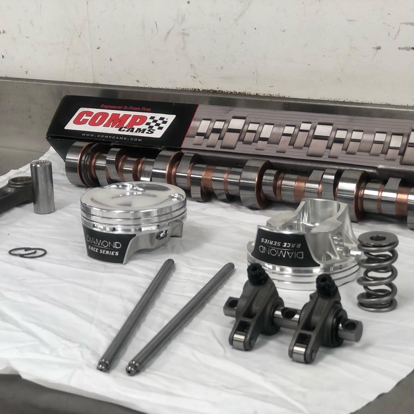 A car engine is sitting on a stand in a garage