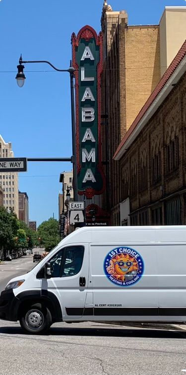 A white van drives past the Alabama Theatre sign in Birmingham, Alabama on a sunny day.