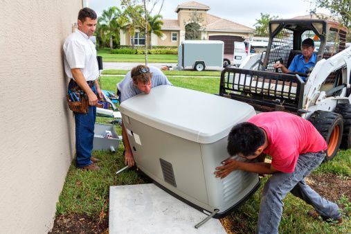 Technicians performing generator installation for a house with tools and equipment.