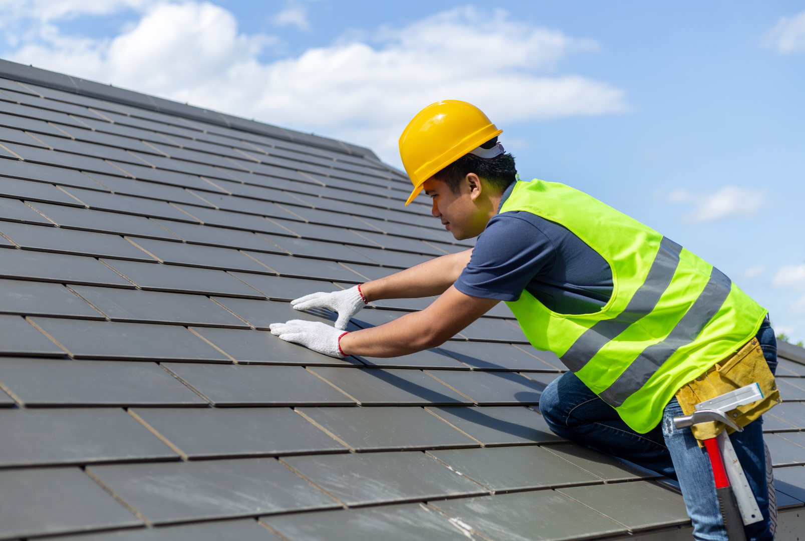 Roofer installing metal shingles on a house in Belleville Ontario
