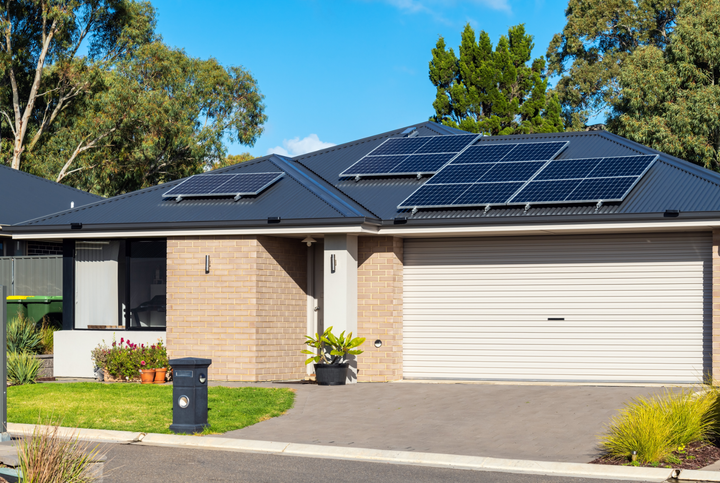 Black standing seam metal roof in Belleville.  The roof has solar panels installed on it.