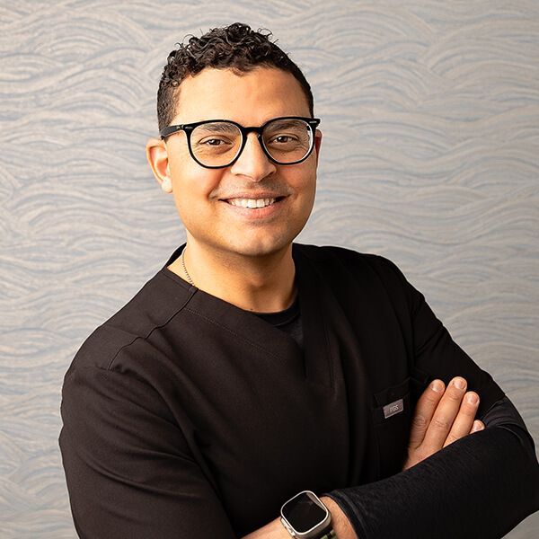 Our amazing Dr. Gabr is ready to help you smile again. Our amazing Dr. Gabr smiling with his arms crossed.