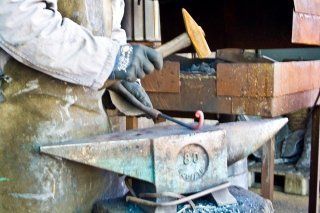 craftsman with anvil and hammer