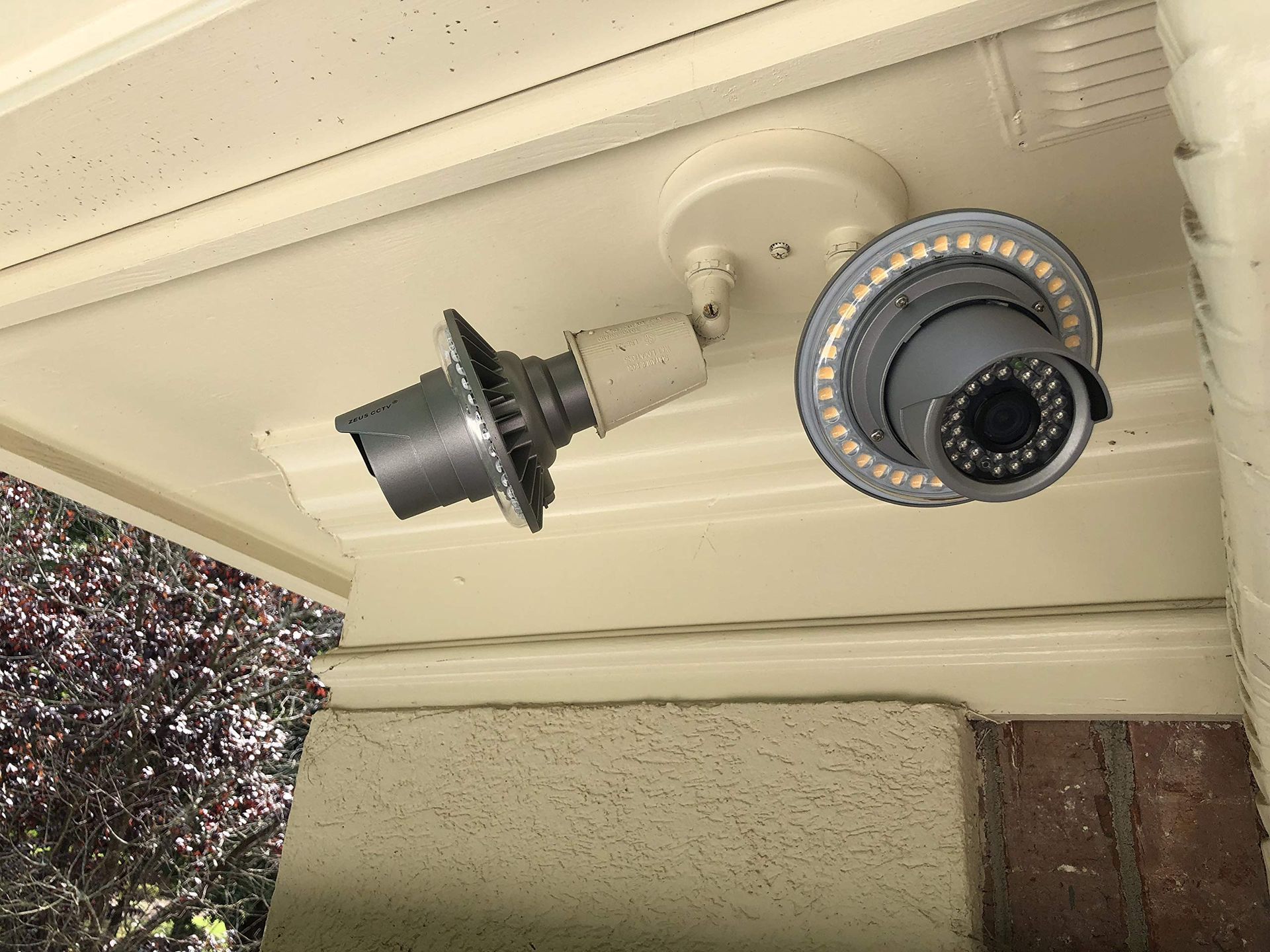 Hands use a key to unlock a door latch and handle.