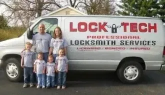 LockTech Professional Locksmith Services van with company logo and four people standing beside it.