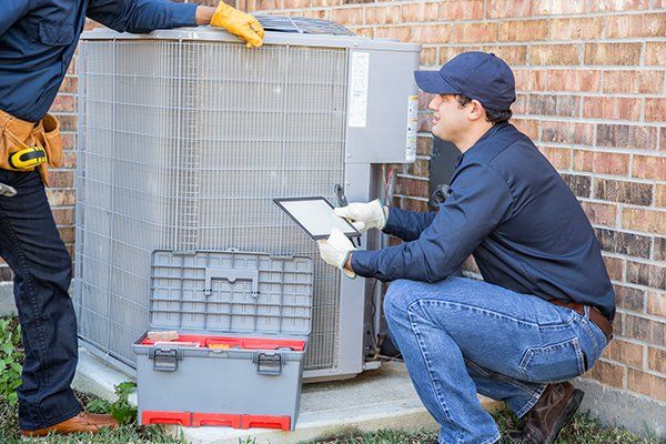 Air Conditioner Repairmen at Work — Killeen, TX — Artie's Heating AC