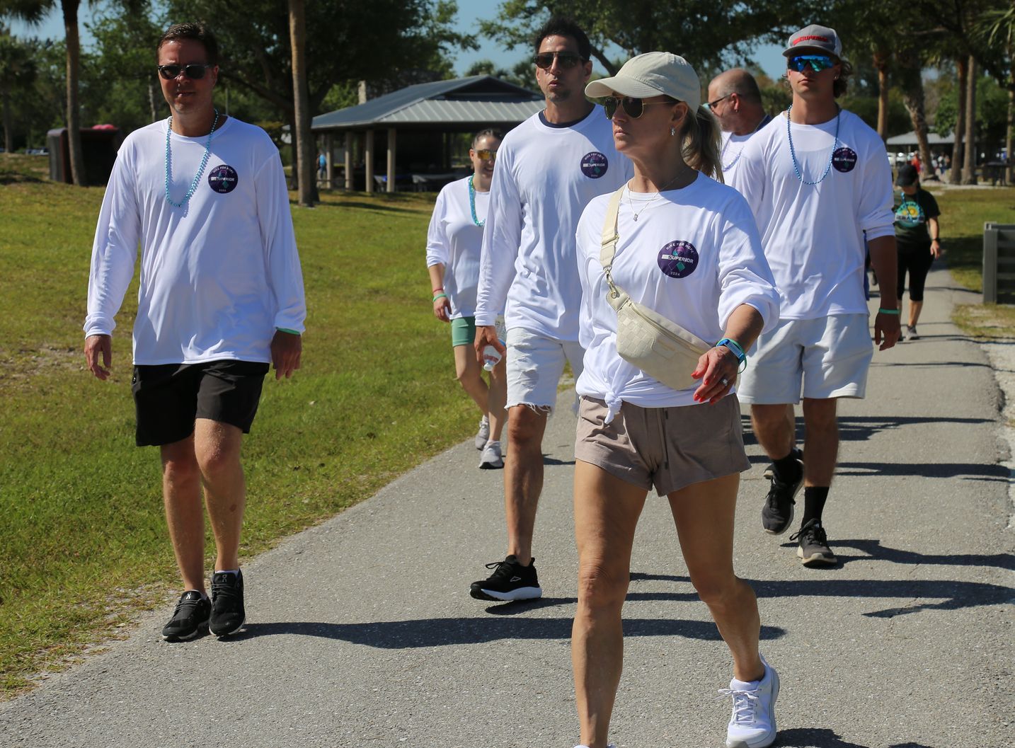 A group of people are walking down a path.