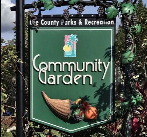 A green sign for the lee county parks and recreation community garden