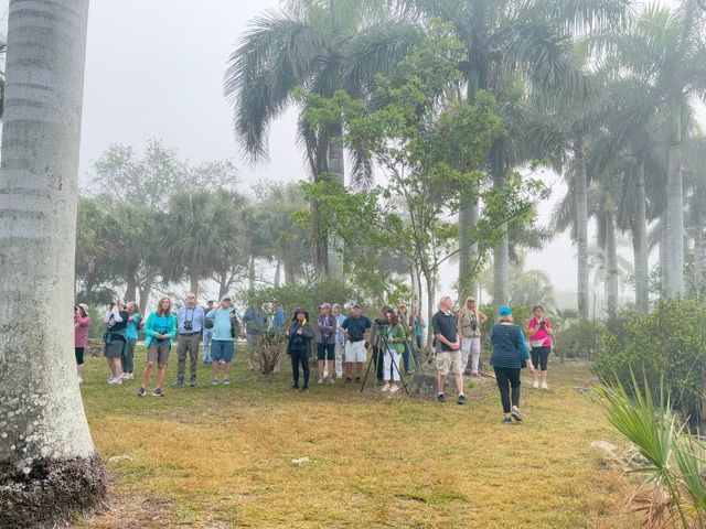 A group of people are posing for a picture in a field.