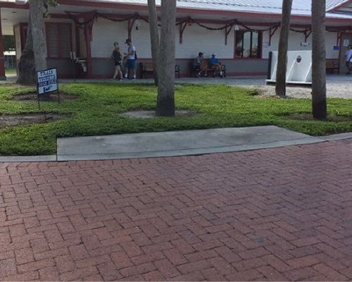 A group of people are walking in front of a building.